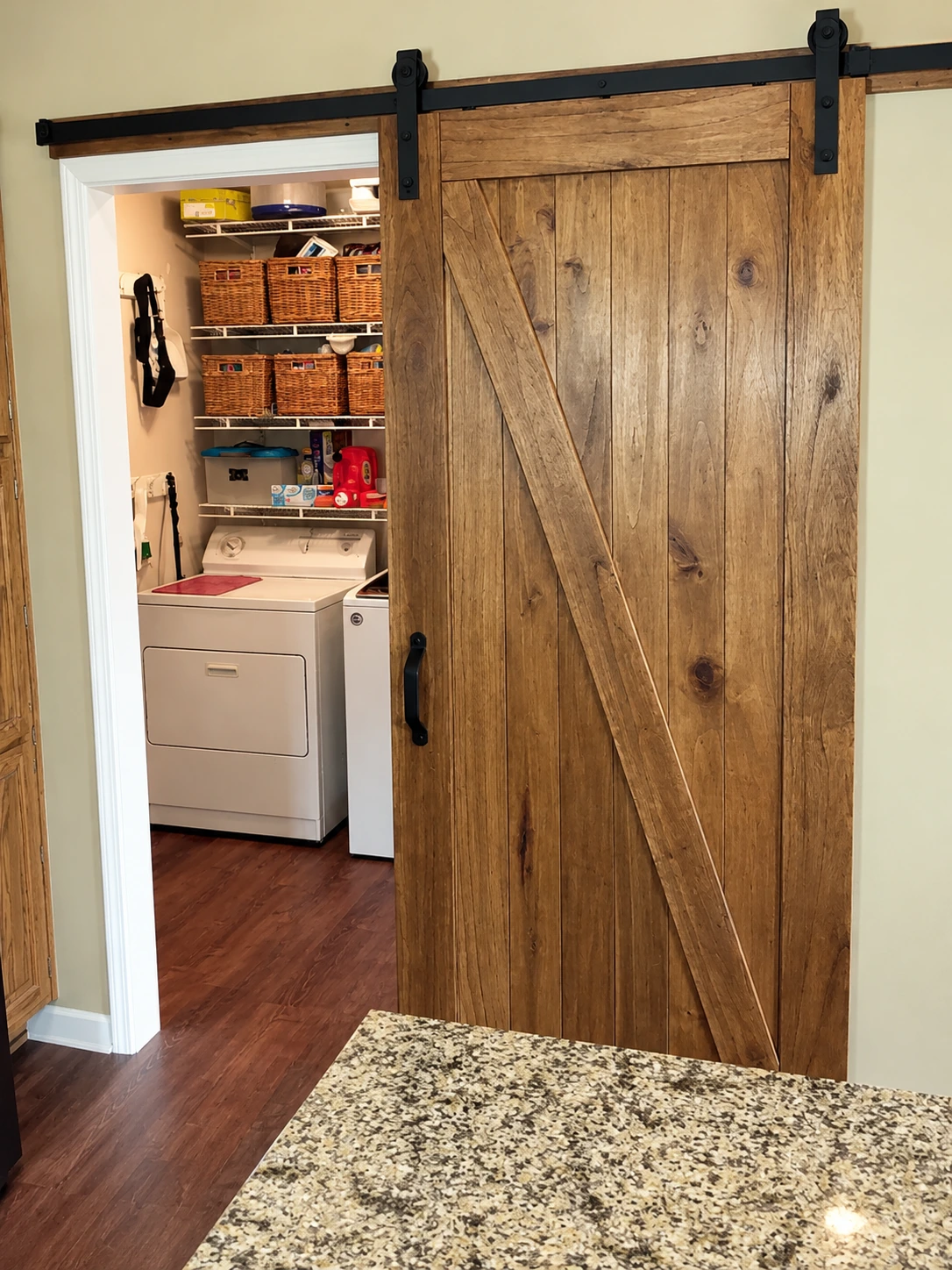 Stained knotty-wood sliding barn door built by D&I Repair