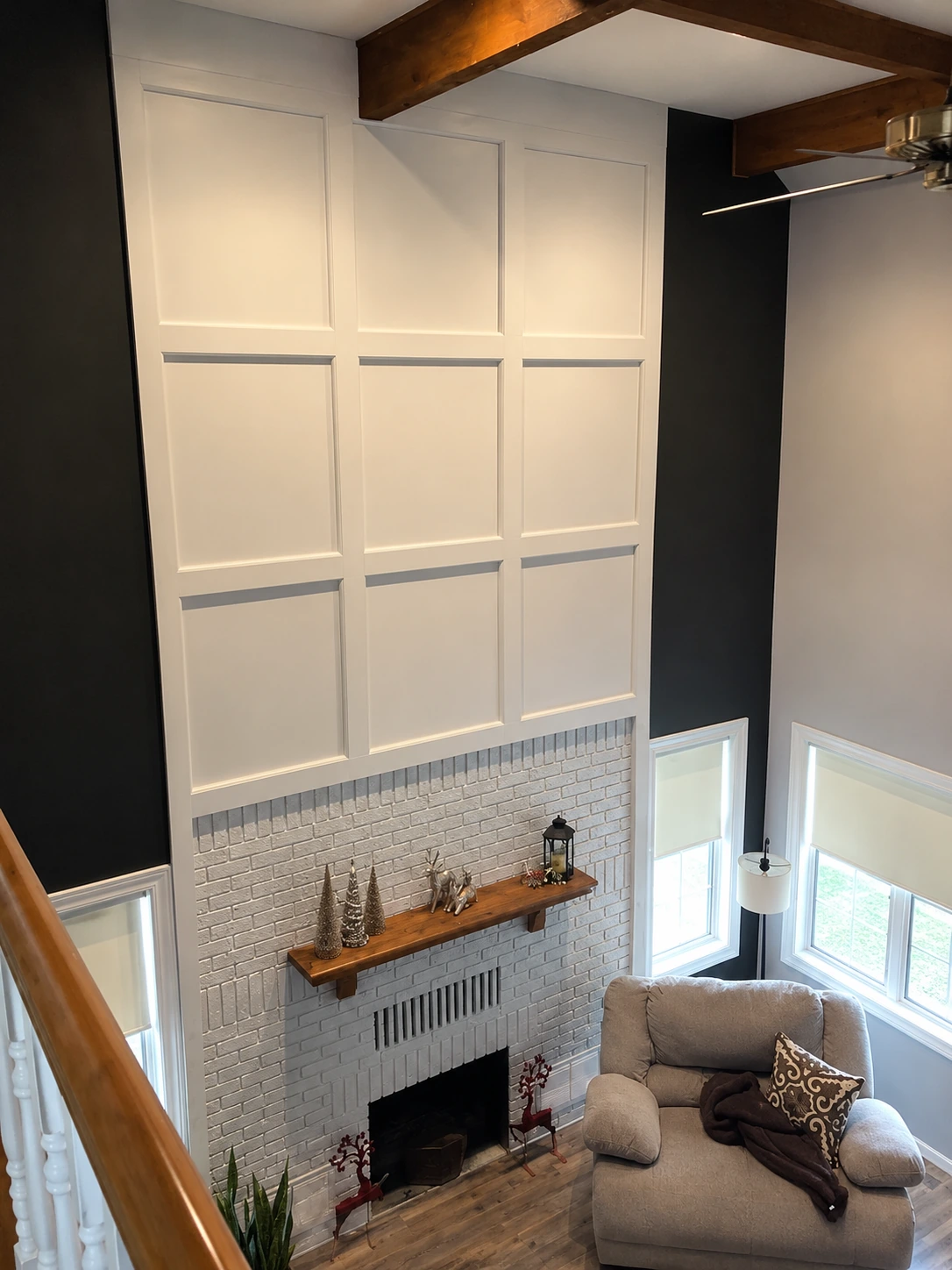 Two-storey board-and-batten wall above a painted brick fireplace